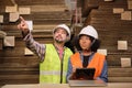 African American Female worker and colleague inspect paper storage warehouse