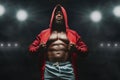 African american fighter in hoodie at boxing ring