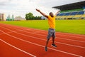 The african american fit athlete doing work out exercises at stadium. The young active male doing jumping exercises Royalty Free Stock Photo