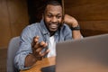 African american freelancer is using laptop, having a video conference. Handsome businessman talking with coworkers on Royalty Free Stock Photo