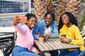 African american friends having breakfast make selfie by the smartphone at coffee shop terrace Royalty Free Stock Photo