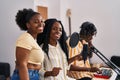 African american friends musicians group singing song at music studio