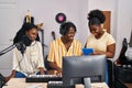 African american friends musicians group singing song using touchpad at music studio