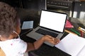 African american girl with afro hair attending online lecture over laptop on table at home Royalty Free Stock Photo