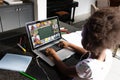 African american girl with afro hair studying through online class over laptop on table at home Royalty Free Stock Photo