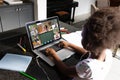 African american girl with afro hair studying in online class over video call on laptop at home Royalty Free Stock Photo