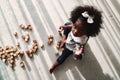 African american girl child playing letter block on floor