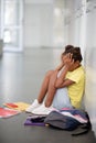 African-American girl crying after bullying by pupils