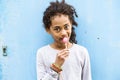 African american girl with curly hair outdoors eating lollipop. Royalty Free Stock Photo