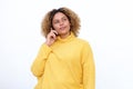 African american girl with curly hair talking on mobile and thinking phone by white background Royalty Free Stock Photo