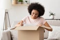 African american girl customer unpacks a box