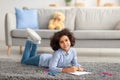 African American girl drawing on paper with colorful crayons Royalty Free Stock Photo