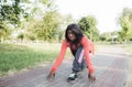 An African-American girl is getting ready for a run. low position to start.