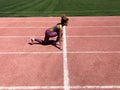 African American girl getting ready to start running.