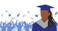 African American girl graduate in mantle and academic square cap on background of cheerful crowd of graduates throwing their Royalty Free Stock Photo