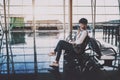 African American girl in hall of airport sending audio message Royalty Free Stock Photo