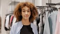 African american girl happy shopper consumer buyer curly woman client looking at camera walking going in clothing Royalty Free Stock Photo