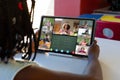 African american girl holding digital tablet with teacher and students on screen studying online Royalty Free Stock Photo