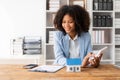 African American girl holds pen to read agreement document to sign land loan with real estate agent or bank teller, Royalty Free Stock Photo