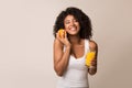 African-american girl with orange and glass of juice Royalty Free Stock Photo