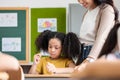 African American girl with pigtails doing exam at classroom Royalty Free Stock Photo