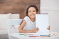 African american girl showing empty drawing album