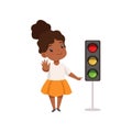 African American Girl Showing Stop Gesture and Pointing Finger at Traffic Light, Traffic Education, Rules, Safety of Royalty Free Stock Photo