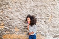 African american girl in striped t-shirt against concrete wall. Royalty Free Stock Photo