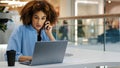 African american girl student curly business woman multitasking female manager worker consultant talking on phone typing Royalty Free Stock Photo