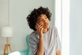 African american girl talking on smartphone at home indoor. Young woman with cell phone chatting with friends. Smiling Royalty Free Stock Photo