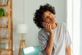 African american girl talking on smartphone at home indoor. Young woman with cell phone chatting with friends. Smiling Royalty Free Stock Photo