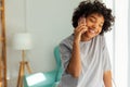 African american girl talking on smartphone at home indoor. Young woman with cell phone chatting with friends. Smiling Royalty Free Stock Photo