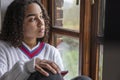 African American girl teenager female young woman sad depressed looking out of a window Royalty Free Stock Photo