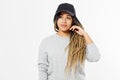 African american girl in template blank sweatshirt and cap on white background. Front pullover and hat view. Copy space Royalty Free Stock Photo