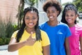 African american girl with two girlfriends showing thumb Royalty Free Stock Photo