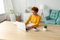 African american girl using laptop at home office looking at screen typing chatting reading writing email. Young woman Royalty Free Stock Photo