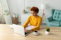 African american girl using laptop at home office looking at screen typing chatting reading writing email. Young woman