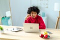 African american girl using laptop at home office looking at screen typing chatting reading writing email. Young woman Royalty Free Stock Photo