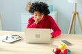 African american girl using laptop at home office looking at screen typing chatting reading writing email. Young woman Royalty Free Stock Photo