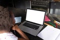African american girl wearing headphones attending online lecture over laptop on table at home Royalty Free Stock Photo