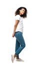 African american girl in white t-shirt standing in blue jeans isolated on white