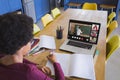 African american girl writing in notebook while teacher giving notes over video call on laptop Royalty Free Stock Photo