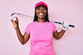 African american golfer woman with braids holding golf ball smiling with a happy and cool smile on face Royalty Free Stock Photo