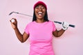 African american golfer woman with braids holding golf ball smiling and laughing hard out loud because funny crazy joke Royalty Free Stock Photo
