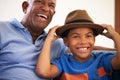 African American Grandfather And Grandson Family Sitting On Sofa With Boy Wearing Hat Royalty Free Stock Photo