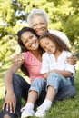 African American Grandmother, Mother And Daughter Relaxing In Pa