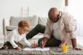 African American Grandpa And Grandson Sketching Sitting On Floor Indoors Royalty Free Stock Photo