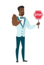 African-american groom holding stop road sign.