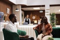 African american guests in lounge area Royalty Free Stock Photo