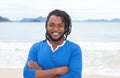 African american guy with dreadlocks and crossed arms at beach Royalty Free Stock Photo